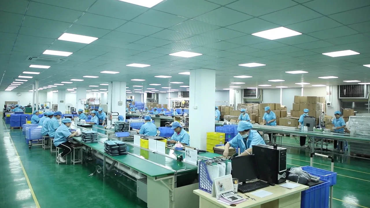 Wide view of staffed personal care appliance assembly lines inside the AIMEI factory.